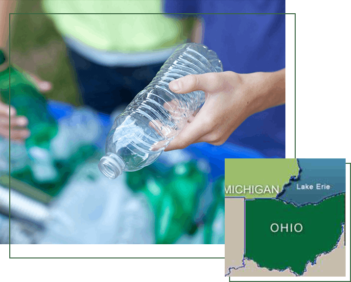 Hands placing bottles in recycling bin with map